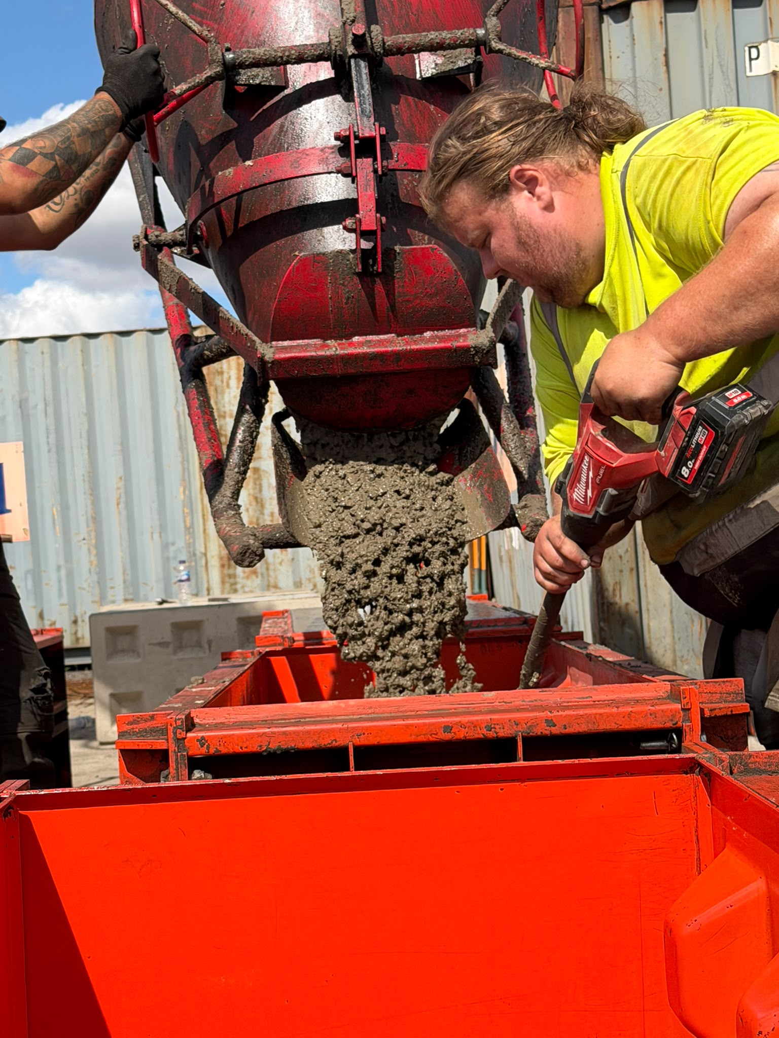 Paton team member pouring concrete into a Beton block mould